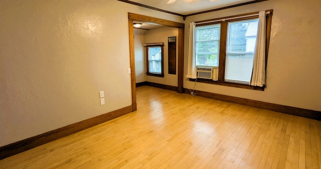 191 Bates St, Pittsfield, ME 04967 - spare room featuring light wood-style flooring, ornamental molding, cooling unit, and a textured wall