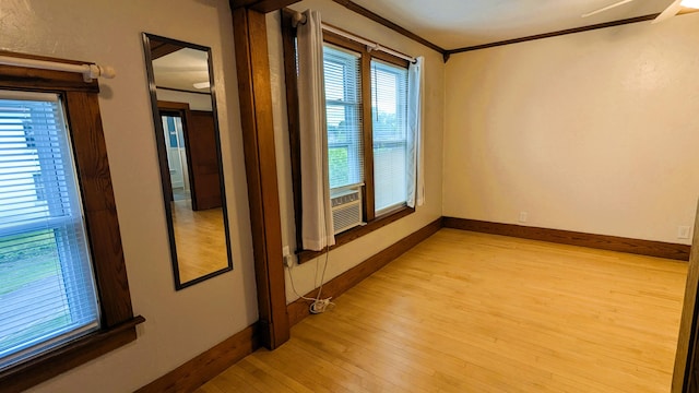 191 Bates St, Pittsfield, ME 04967 - spare room with light wood-style floors, crown molding, and cooling unit