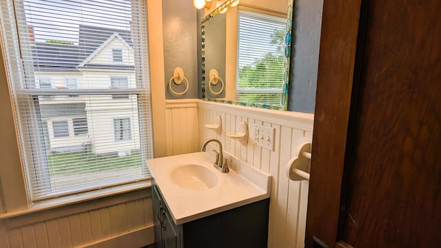 191 Bates St, Pittsfield, ME 04967 - bathroom featuring wainscoting, vanity, and a decorative wall