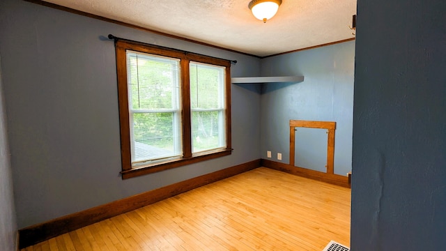 191 Bates St, Pittsfield, ME 04967 - spare room with light wood-style flooring, crown molding, and a textured ceiling