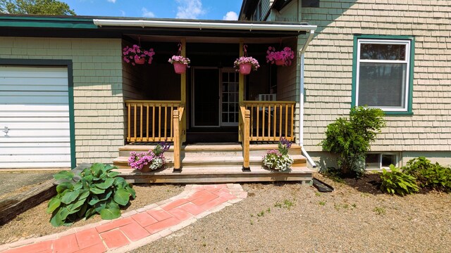 191 Bates St, Pittsfield, ME 04967 - view of exterior entry with covered porch and a garage