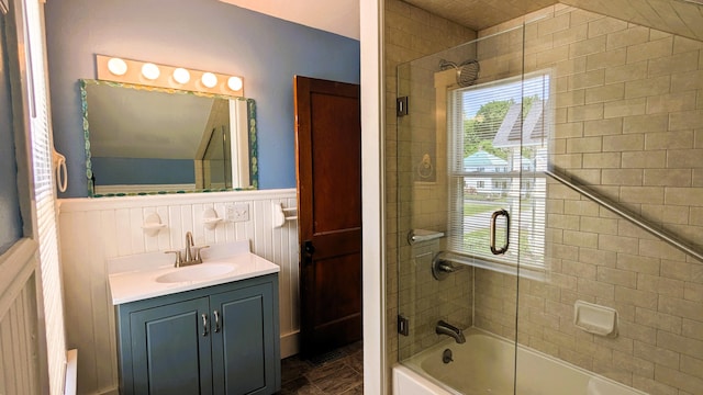 191 Bates St, Pittsfield, ME 04967 - bathroom featuring bath / shower combo with glass door, vanity, and wainscoting