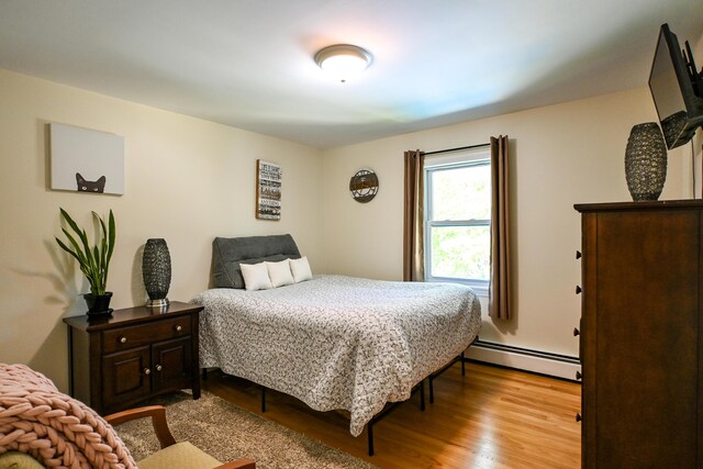 77 Carter St, Portland, ME 04103 - bedroom with a baseboard heating unit and wood finished floors