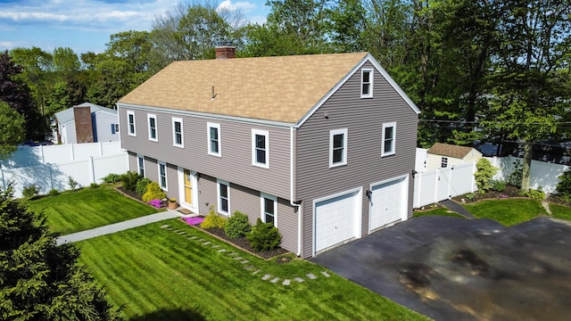 77 Carter St, Portland, ME 04103 - colonial inspired home with a chimney, a shingled roof, a garage, and driveway