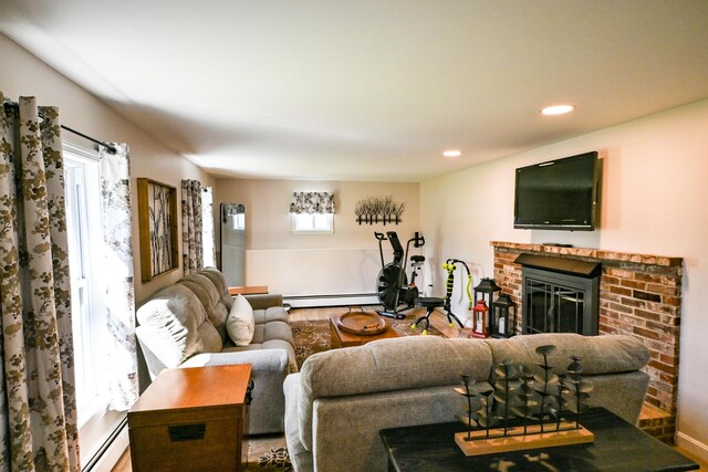 77 Carter St, Portland, ME 04103 - living room with a brick fireplace, recessed lighting, baseboard heating, and wood finished floors