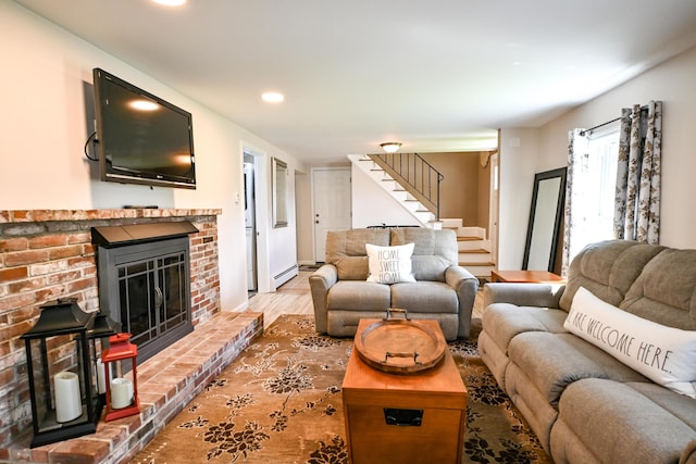 77 Carter St, Portland, ME 04103 - living area with stairway, a fireplace, wood finished floors, a baseboard radiator, and recessed lighting