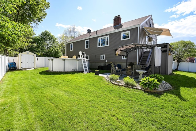 77 Carter St, Portland, ME 04103 - back of house with a chimney, a pergola, a patio, and a storage unit