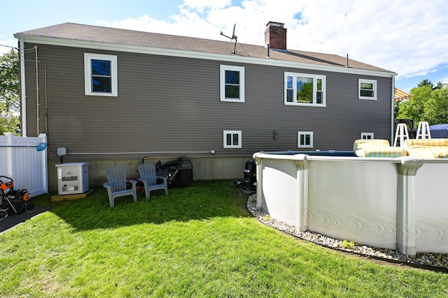 77 Carter St, Portland, ME 04103 - back of property featuring a chimney, an outdoor pool, and roof with shingles
