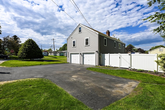 77 Carter St, Portland, ME 04103 - view of property exterior featuring a chimney, a gate, asphalt driveway, and an attached garage