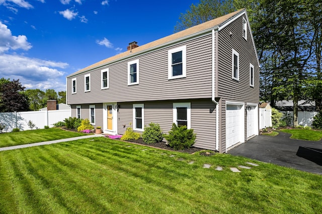 77 Carter St, Portland, ME 04103 - colonial house featuring a chimney, a garage, and asphalt driveway