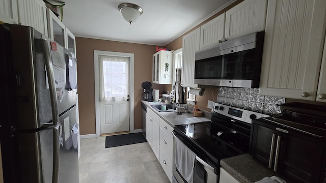 2 Fairview Ave, Houlton, ME 04730 - kitchen with stainless steel appliances, glass insert cabinets, crown molding, white cabinetry, and baseboards