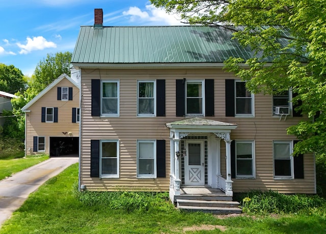 26 Unity Rd, Albion, ME 04910 - view of front of home featuring driveway, a chimney, metal roof, and a garage