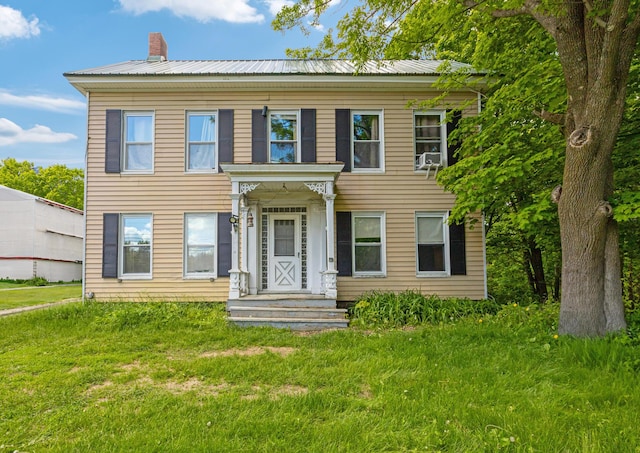 26 Unity Rd, Albion, ME 04910 - view of front of home with metal roof, a chimney, and a front lawn