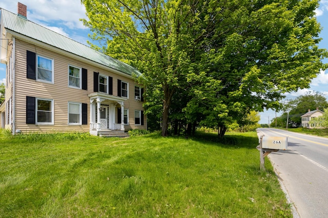 26 Unity Rd, Albion, ME 04910 - colonial home with metal roof, a chimney, and a front lawn