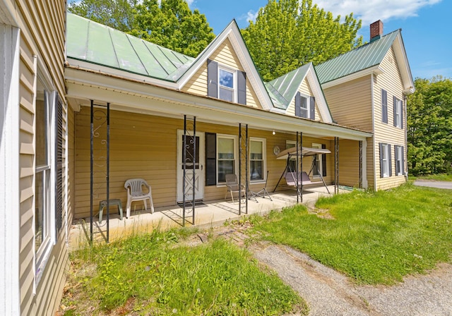 26 Unity Rd, Albion, ME 04910 - rear view of house featuring metal roof and a lawn