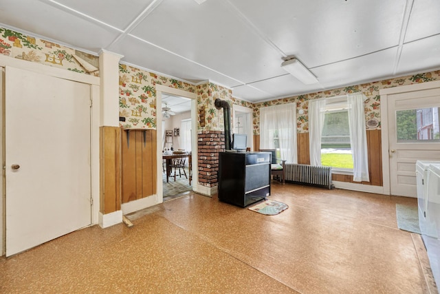 26 Unity Rd, Albion, ME 04910 - office space featuring radiator heating unit, wallpapered walls, a wood stove, wainscoting, and baseboards