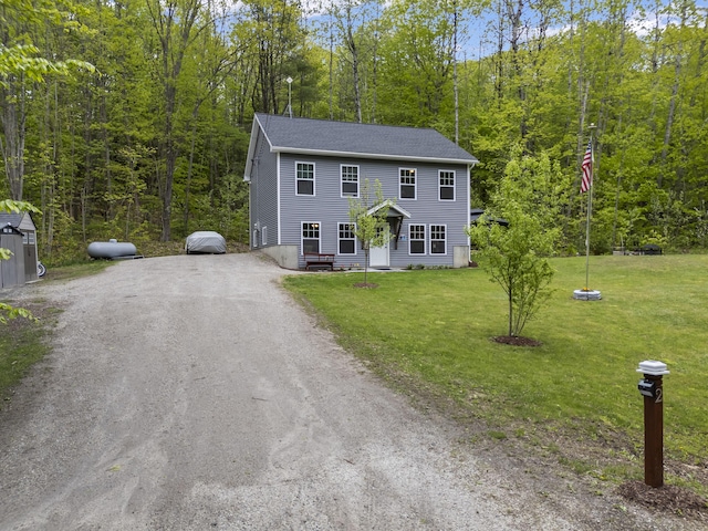 2 Ball Park Rd, Lewiston, ME 04240 - colonial home with driveway, a wooded view, and a front lawn