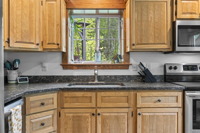 2 Ball Park Rd, Lewiston, ME 04240 - kitchen with stainless steel appliances, a sink, and dark stone countertops