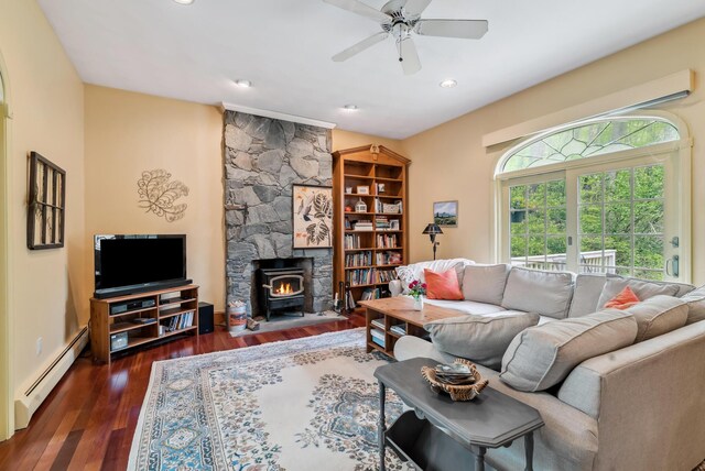 3 Payneton Hill Rd, York, ME 03909 - living room featuring baseboard heating, a wood stove, wood finished floors, and a ceiling fan