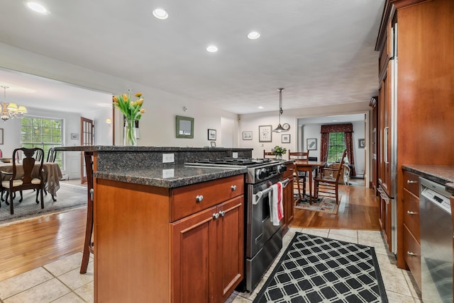 3 Payneton Hill Rd, York, ME 03909 - kitchen featuring appliances with stainless steel finishes, a kitchen breakfast bar, a chandelier, light tile patterned floors, and a center island