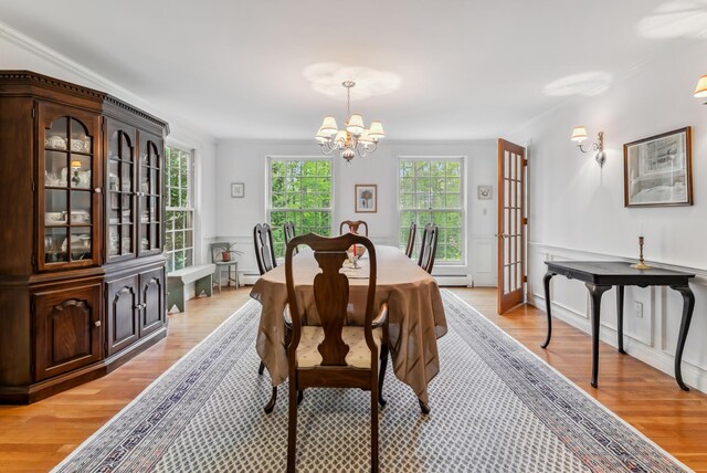 3 Payneton Hill Rd, York, ME 03909 - dining room featuring a chandelier, light wood-type flooring, a wainscoted wall, and a baseboard heating unit