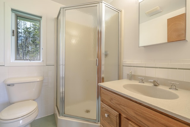 4 Seawall Point Ln, Southwest Harbor, ME 04679 - bathroom featuring tile walls, vanity, a stall shower, toilet, and wainscoting