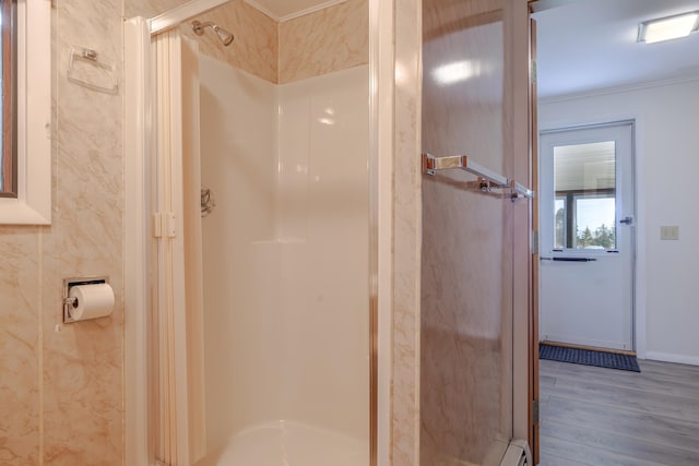 4 Seawall Point Ln, Southwest Harbor, ME 04679 - bathroom featuring a shower stall, wood finished floors, crown molding, and a baseboard heating unit