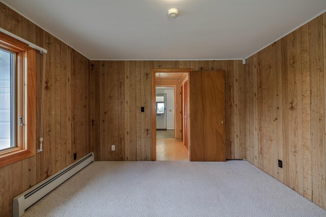 4 Seawall Point Ln, Southwest Harbor, ME 04679 - carpeted empty room featuring a baseboard radiator, wood walls, a smoke detector, and attic access
