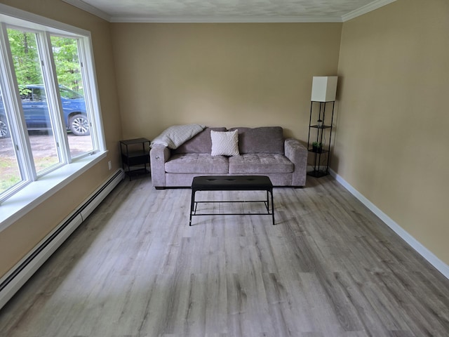 60 Rolling Rdg, Jay, ME 04239 - living area with a baseboard radiator, wood finished floors, baseboards, and crown molding