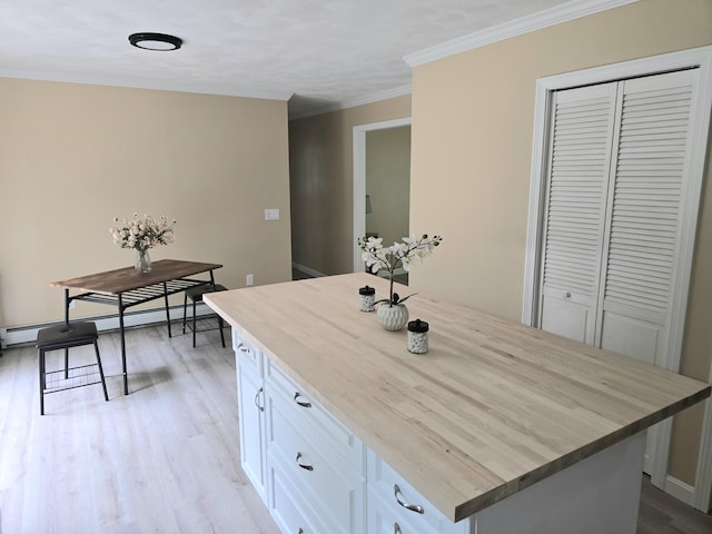 60 Rolling Rdg, Jay, ME 04239 - kitchen with butcher block counters, white cabinets, light wood-type flooring, ornamental molding, and a kitchen island