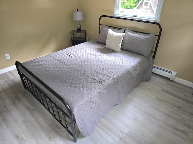 60 Rolling Rdg, Jay, ME 04239 - bedroom featuring a baseboard heating unit, wood finished floors, and baseboards