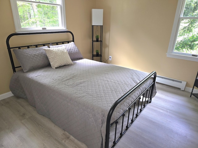 60 Rolling Rdg, Jay, ME 04239 - bedroom with baseboard heating, wood finished floors, and baseboards