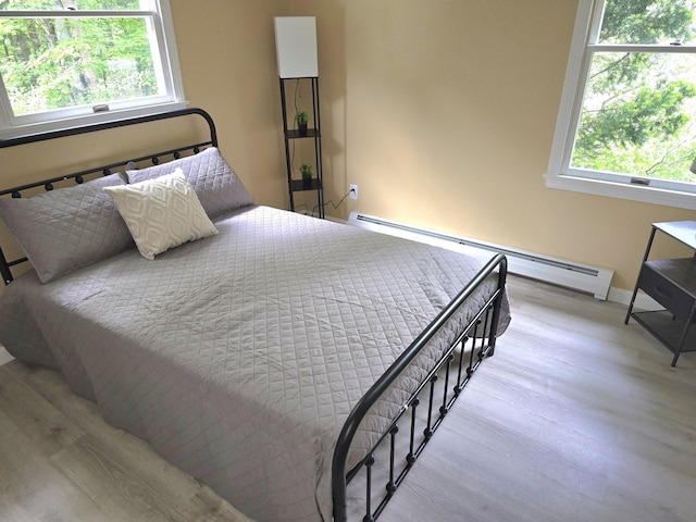 60 Rolling Rdg, Jay, ME 04239 - bedroom with a baseboard radiator, wood finished floors, multiple windows, and baseboards