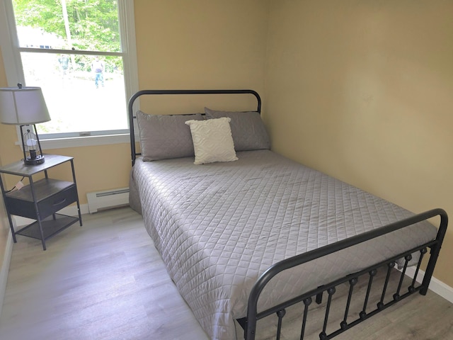 60 Rolling Rdg, Jay, ME 04239 - bedroom featuring a baseboard radiator, light wood-style floors, and baseboards