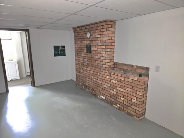 60 Rolling Rdg, Jay, ME 04239 - finished below grade area featuring brick wall, a drop ceiling, and baseboard heating
