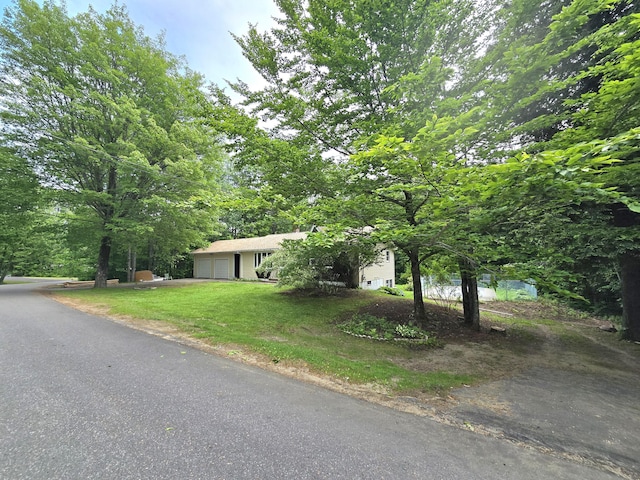 60 Rolling Rdg, Jay, ME 04239 - view of front of home featuring an attached garage, a front lawn, and driveway