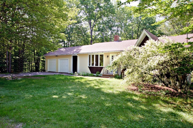 60 Rolling Rdg, Jay, ME 04239 - view of front facade featuring a garage, driveway, a chimney, and a front yard