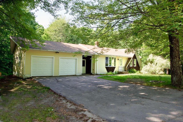 60 Rolling Rdg, Jay, ME 04239 - view of front of property with an attached garage, driveway, and a chimney
