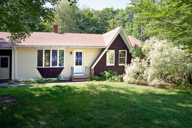 60 Rolling Rdg, Jay, ME 04239 - view of front facade with a chimney, a front yard, and a shingled roof