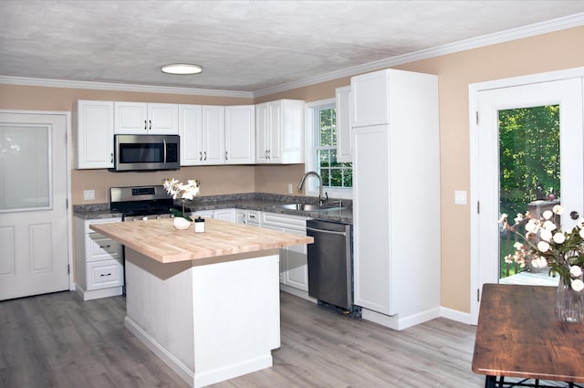 60 Rolling Rdg, Jay, ME 04239 - kitchen with stainless steel appliances, butcher block counters, white cabinets, light wood finished floors, and a center island