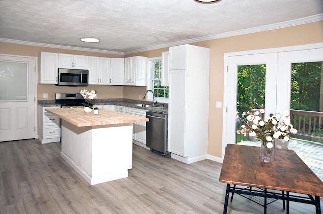 60 Rolling Rdg, Jay, ME 04239 - kitchen with appliances with stainless steel finishes, butcher block countertops, white cabinetry, a center island, and light wood-style flooring
