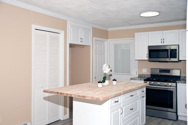60 Rolling Rdg, Jay, ME 04239 - kitchen with appliances with stainless steel finishes, white cabinets, wood finished floors, a center island, and ornamental molding