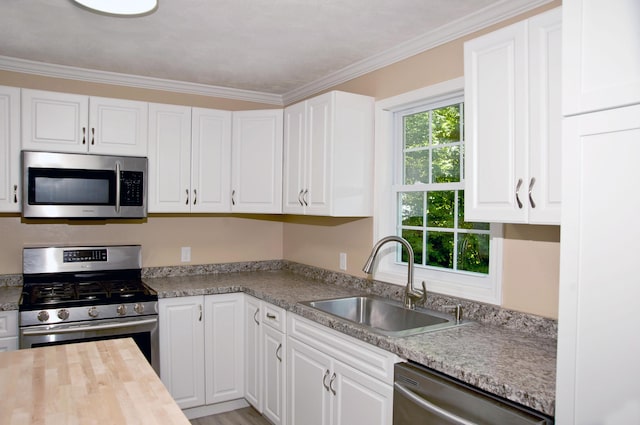 60 Rolling Rdg, Jay, ME 04239 - kitchen with appliances with stainless steel finishes, white cabinetry, ornamental molding, and butcher block counters