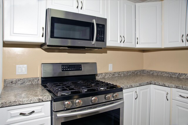 60 Rolling Rdg, Jay, ME 04239 - kitchen featuring appliances with stainless steel finishes, white cabinets, and light countertops