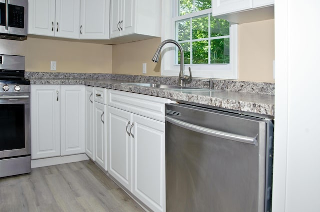 60 Rolling Rdg, Jay, ME 04239 - kitchen with appliances with stainless steel finishes, white cabinets, and light wood finished floors