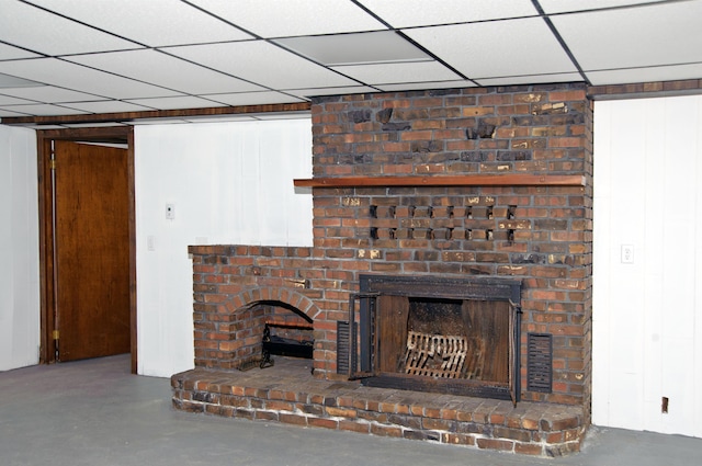 60 Rolling Rdg, Jay, ME 04239 - unfurnished living room featuring a brick fireplace and concrete flooring