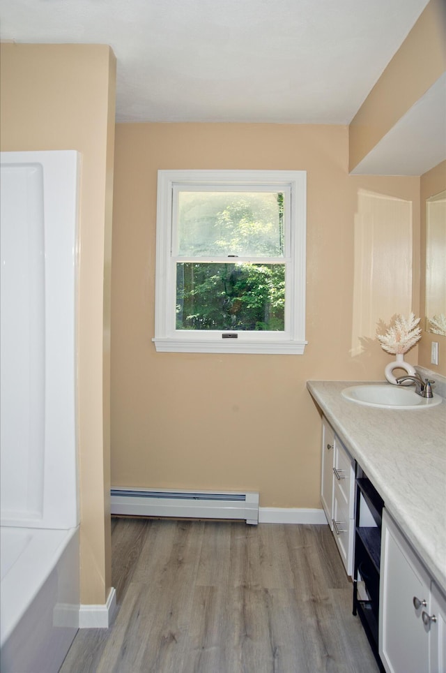 60 Rolling Rdg, Jay, ME 04239 - full bath with baseboard heating, vanity, wood finished floors, and a bath