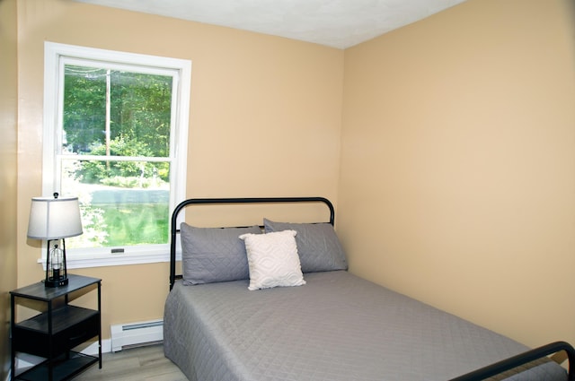 60 Rolling Rdg, Jay, ME 04239 - bedroom featuring a baseboard heating unit and wood finished floors