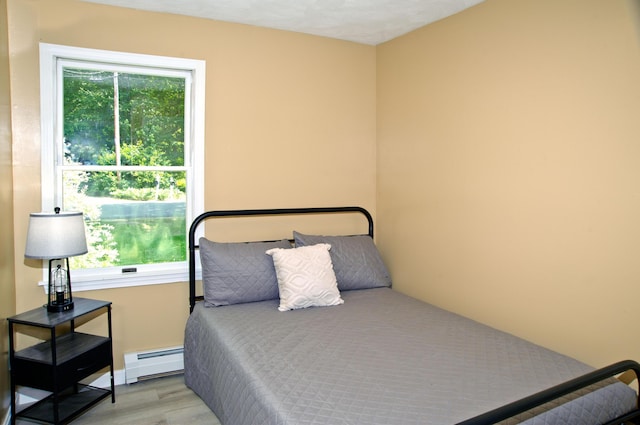 60 Rolling Rdg, Jay, ME 04239 - bedroom with a baseboard heating unit and wood finished floors