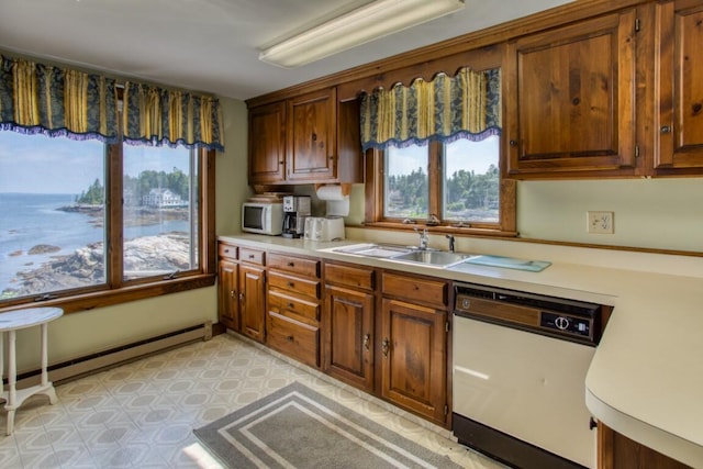 16 Tilton Ln, Southport, ME 04576 - kitchen with white appliances, light countertops, a sink, and brown cabinetry